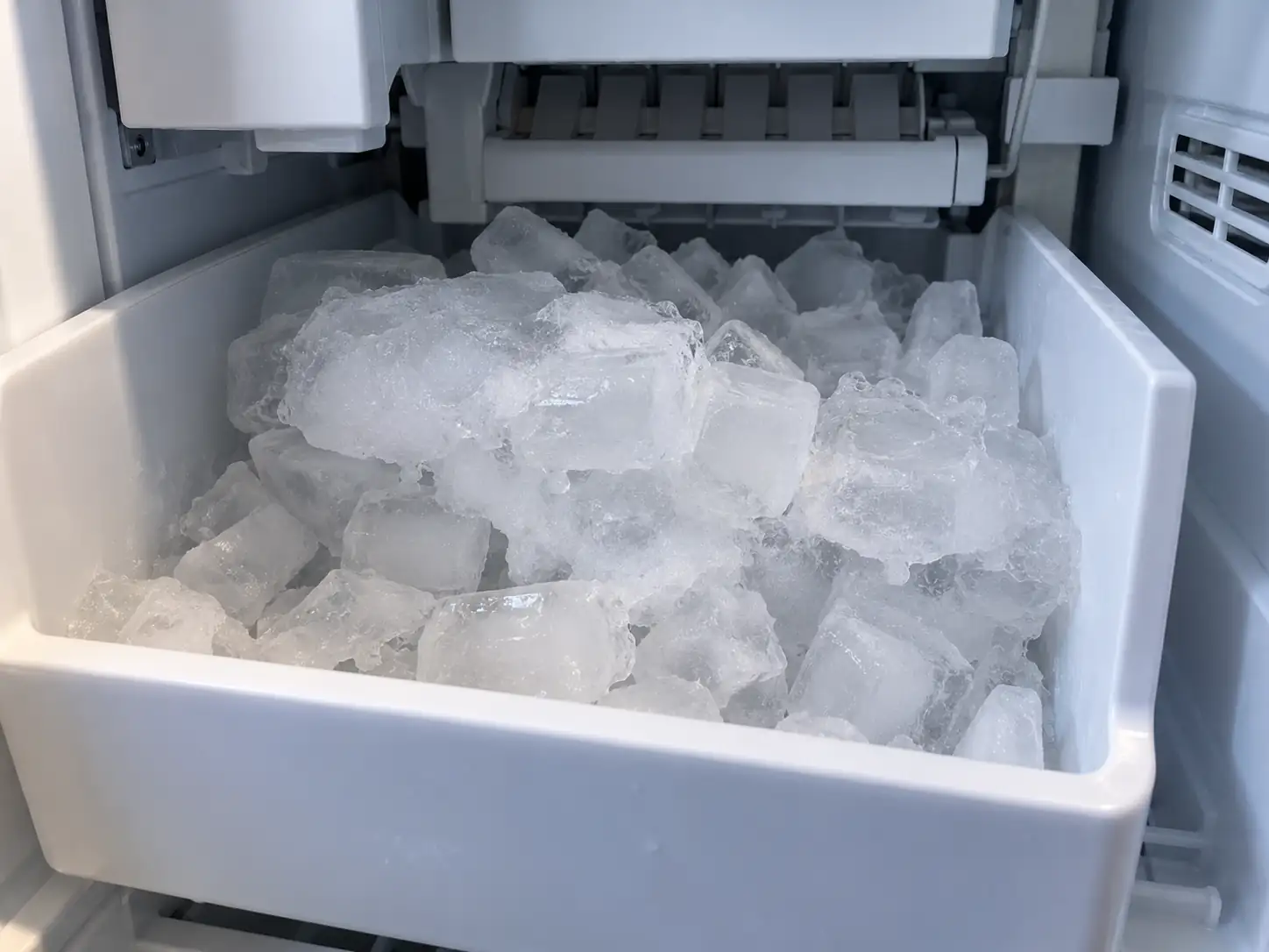 Ice maker freezing up with ice clumps and jams in the refrigerator ice bin