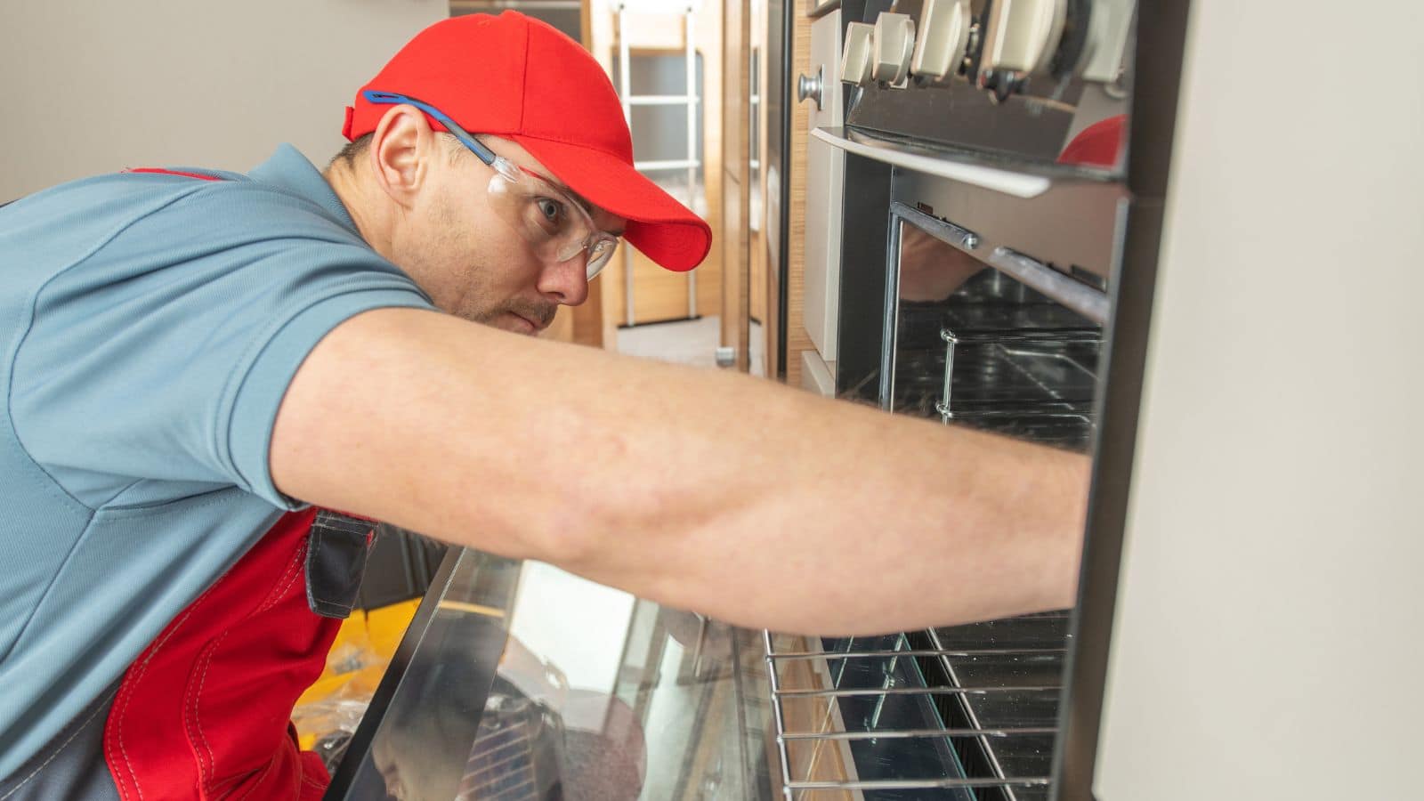 RV Technician replacing broken recreational vehicle stove.